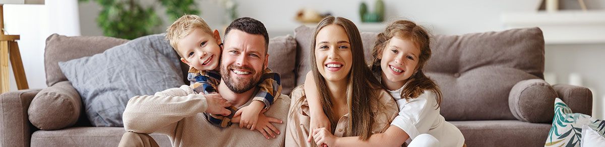 cute family of 4 smiling at the camera