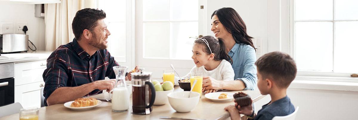 family eatting breakfast at kitchen island