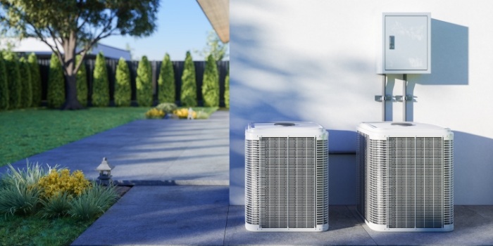 two HVAC units in a backyard